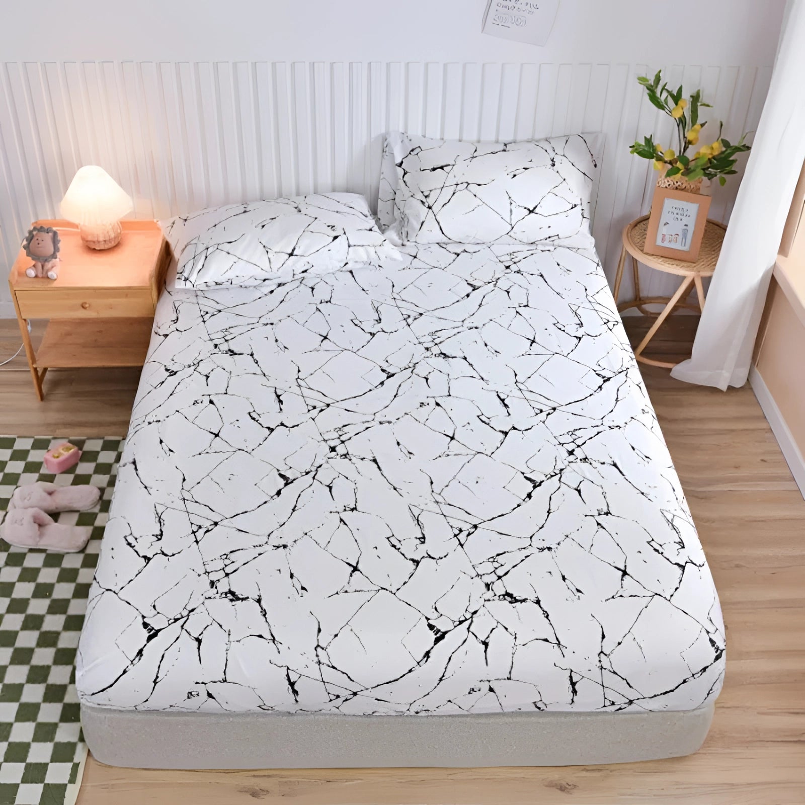 Queen size duvet cover set in blue with a modern botanical pattern featuring floral designs, displayed on a bed within a stylish bedroom setting. The room includes a grey bed frame, wooden floor, and decorative plants, highlighting the comfort and elegance of the bedding.