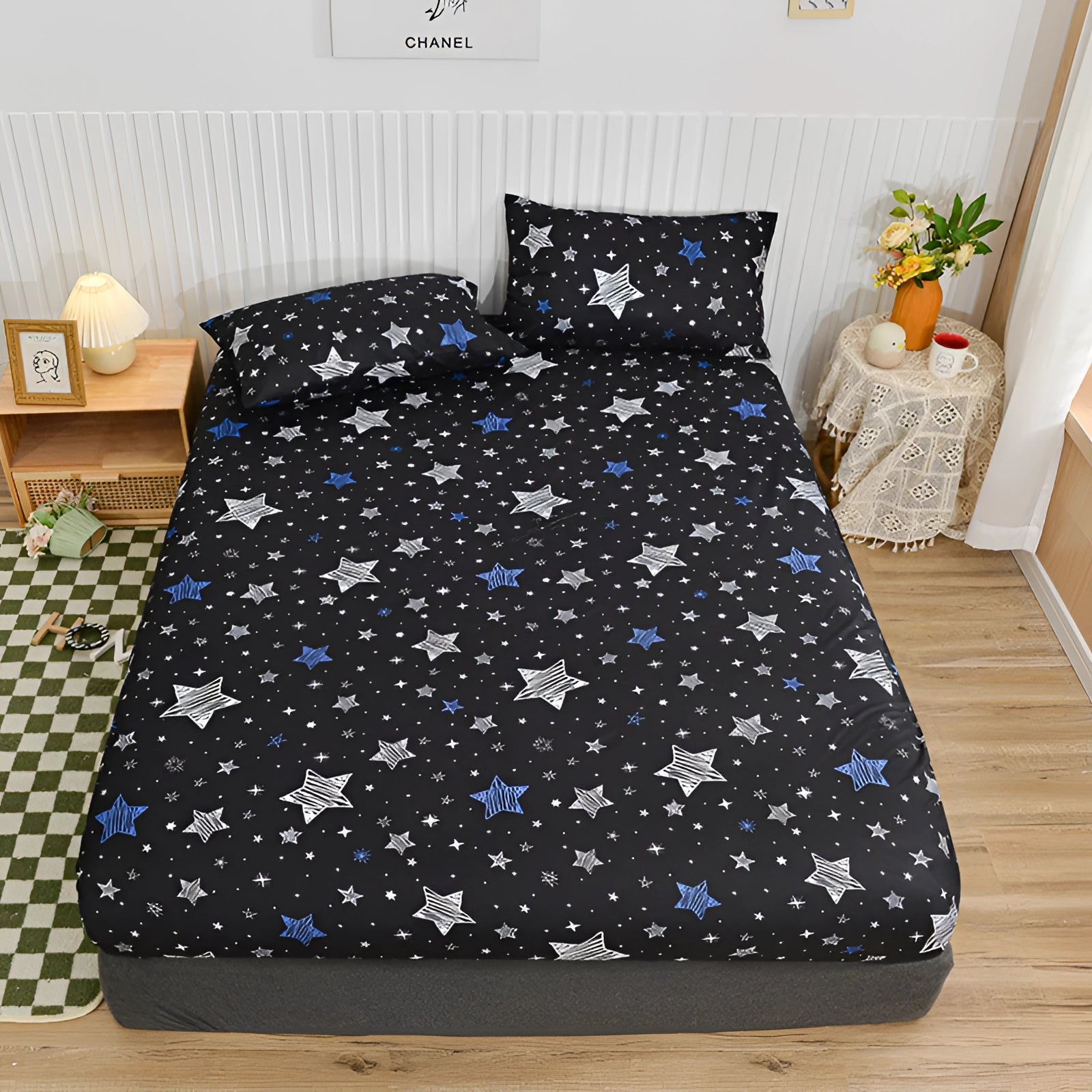 Queen size bed dressed in a blue floral duvet cover set featuring a modern botanical pattern, complemented by houseplants and a wooden bed frame in a cozy bedroom setting.