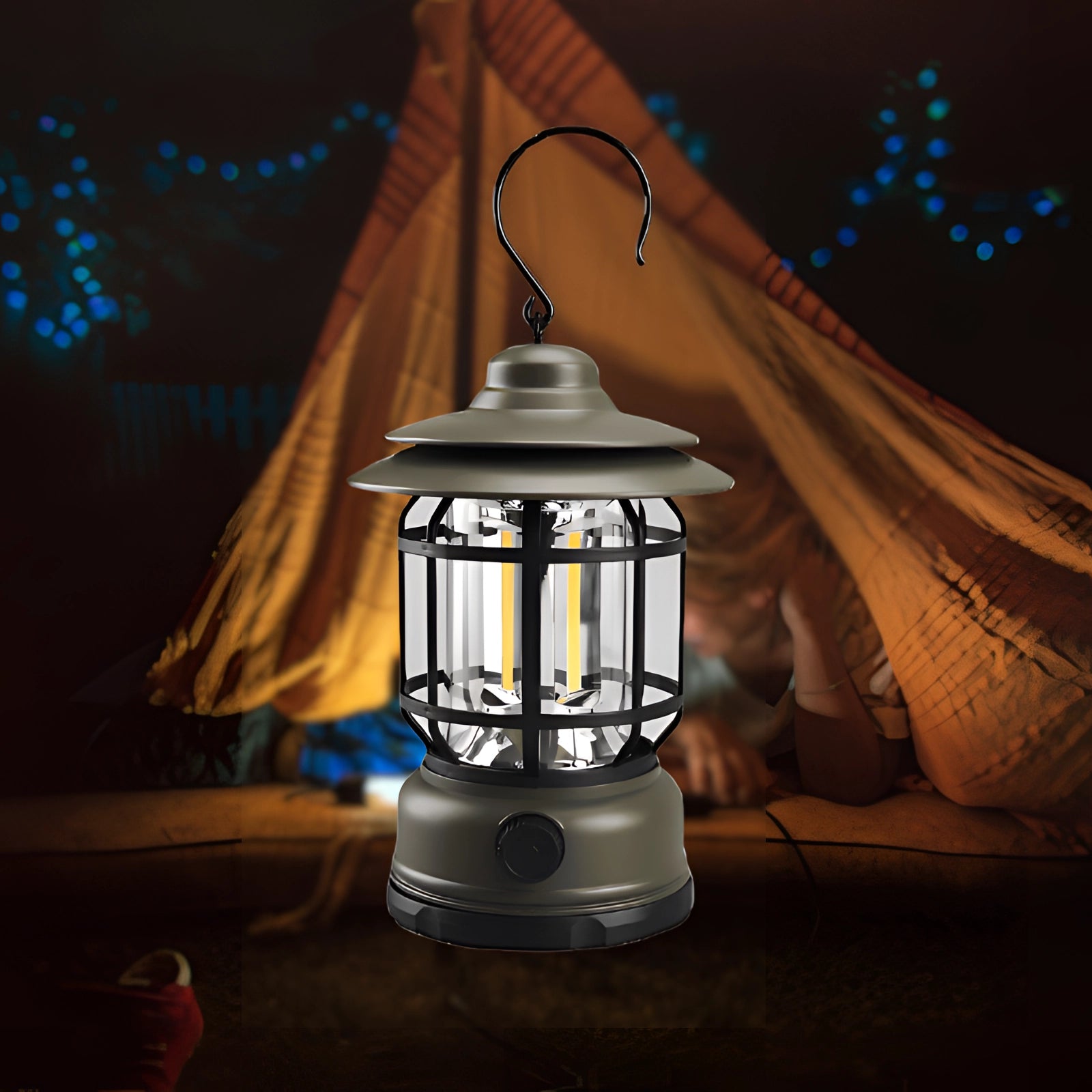 Rechargeable green LED camping lantern, weather-resistant and portable, illuminating a dark outdoor setting with surrounding trees.