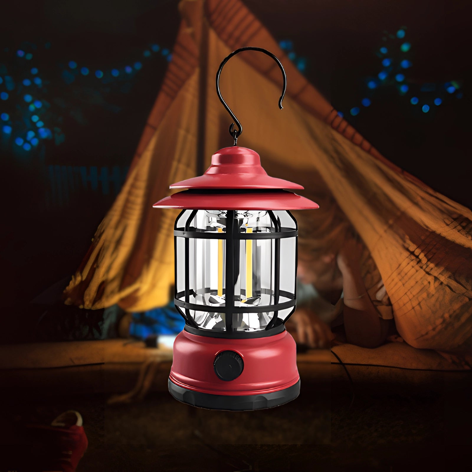 Rechargeable red LED camping lantern illuminated in a dark outdoor setting with trees in the background, showcasing its portability and weather-resistant design.