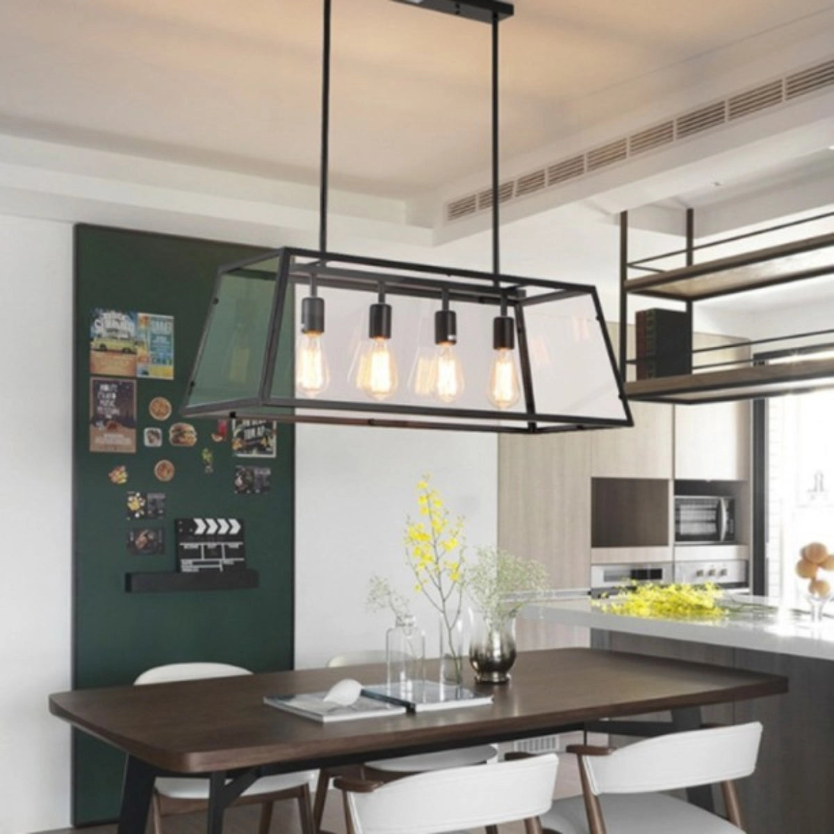 Rectangular industrial chandelier with black metal frame and clear glass panels hanging above a wooden kitchen table in a modern interior setting.