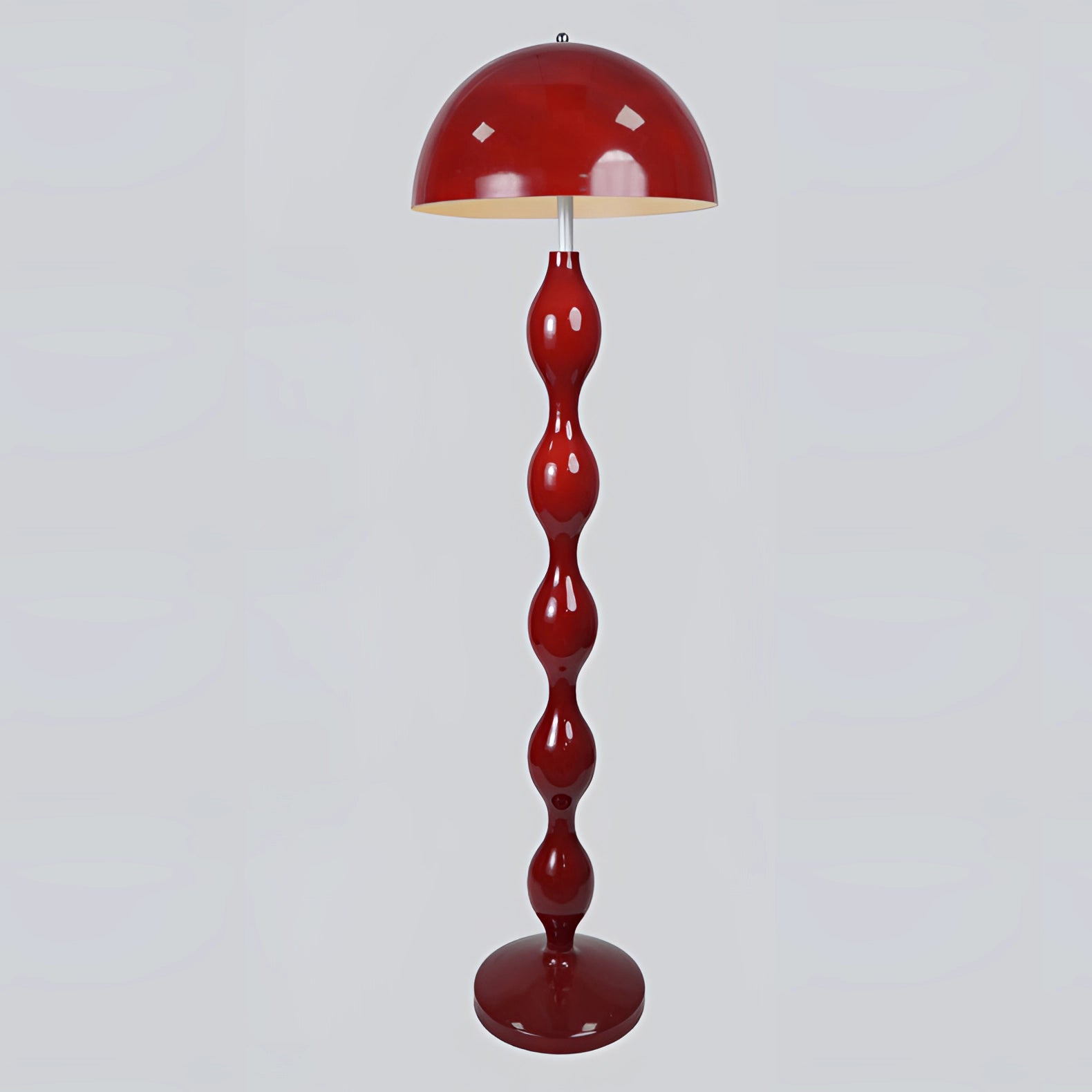 Modern red floor lamp with a wavy, sculptural design, showcasing contemporary art-inspired aesthetics and a sleek finish.