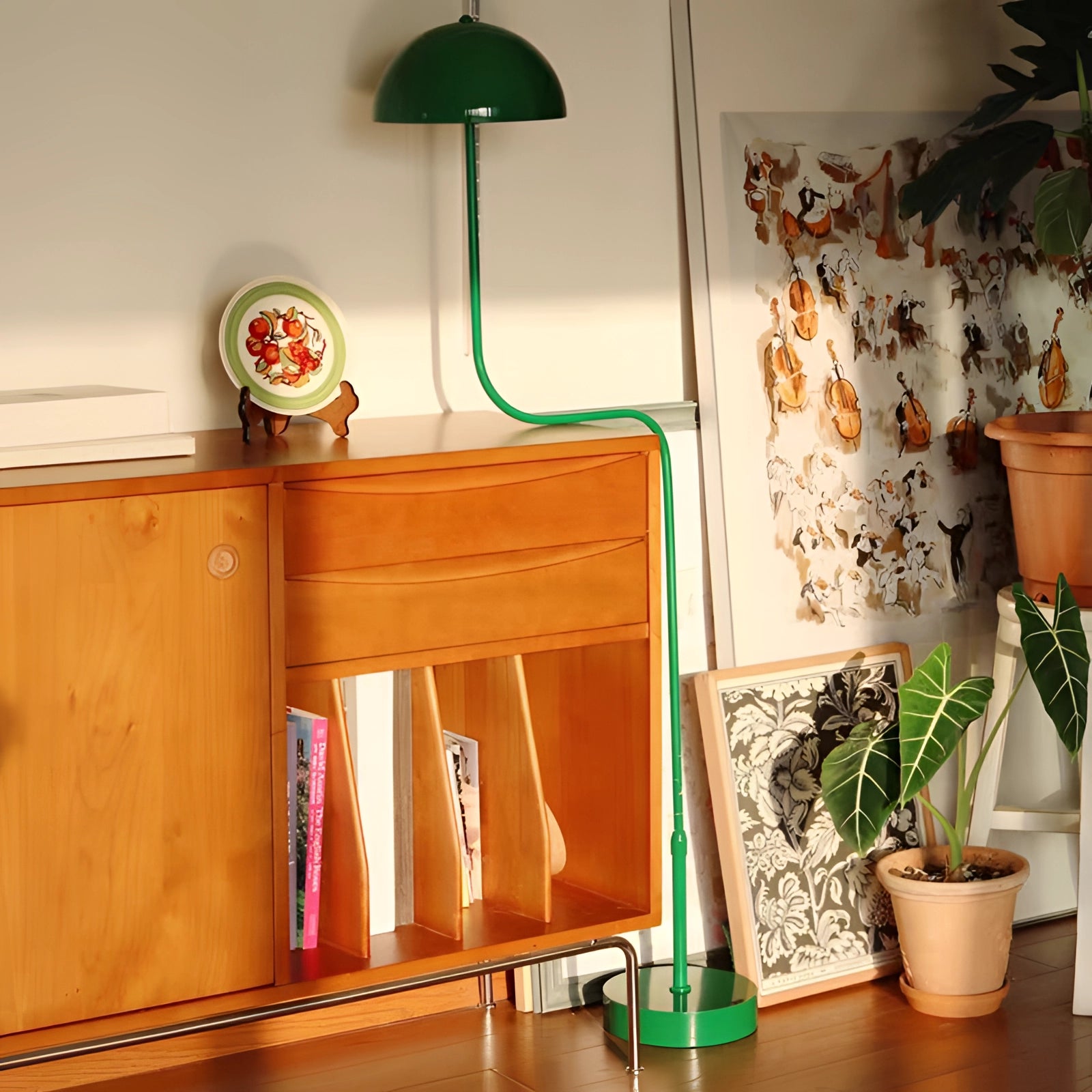 Elegant Retro Art Deco green brass floor lamp positioned next to a green houseplant in a flowerpot, enhancing a stylish interior with wooden flooring and softly illuminated lighting.