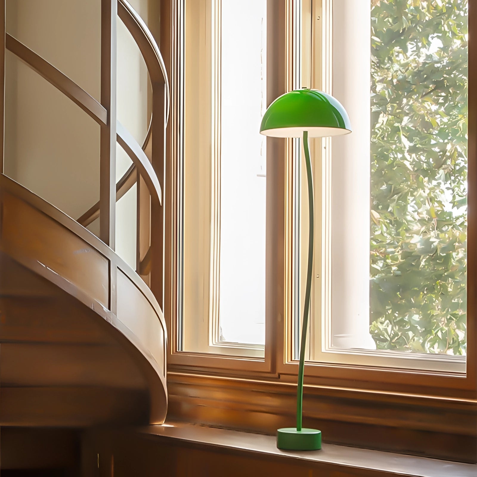 Retro Art Deco green brass floor lamp with a stylish shade, situated in an elegant interior with wooden flooring and large windows, enhancing the home decor with a touch of vintage charm.