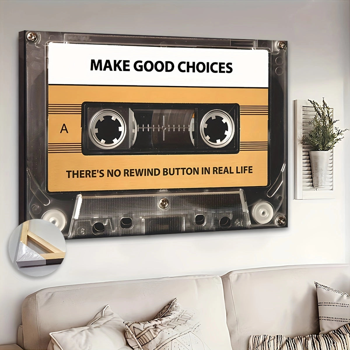 Retro cassette tape wall art featuring the motivational phrase "Make Good Choices," displayed in a picture frame, with decorative plants and a couch in the background.