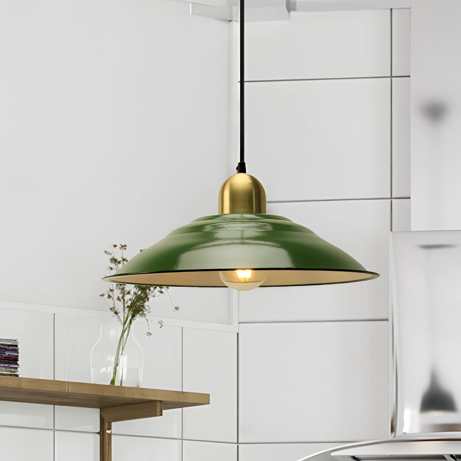Retro green enamel pendant light with gold trim, featuring a vintage design, hanging from a ceiling, enhancing an interior space. The pendant is in a 16-inch size, offering a stylish combination of green and gold hues.
