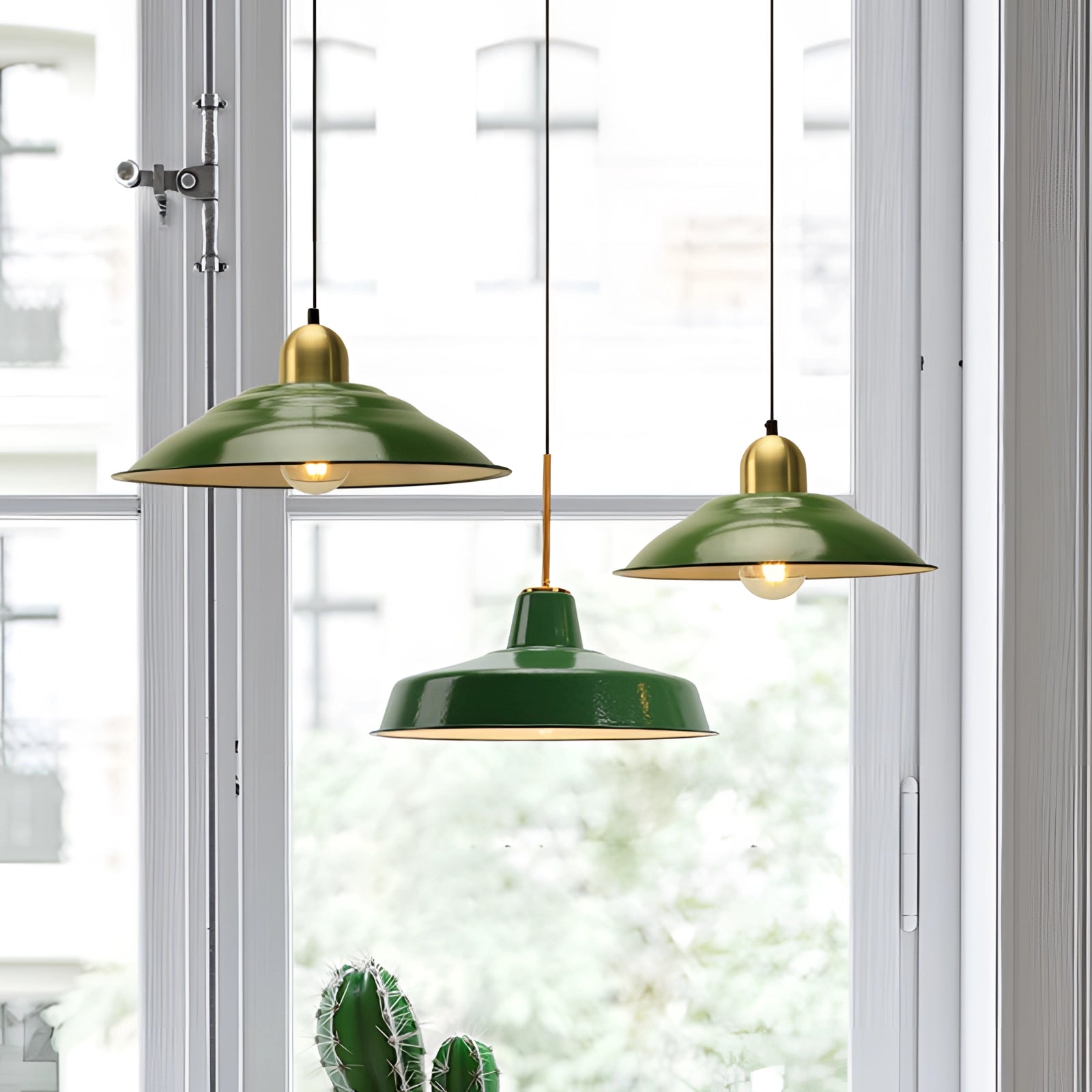 Retro green enamel pendant light with gold trim hanging from the ceiling, featuring a classic vintage design that adds a touch of elegance to the interior space.