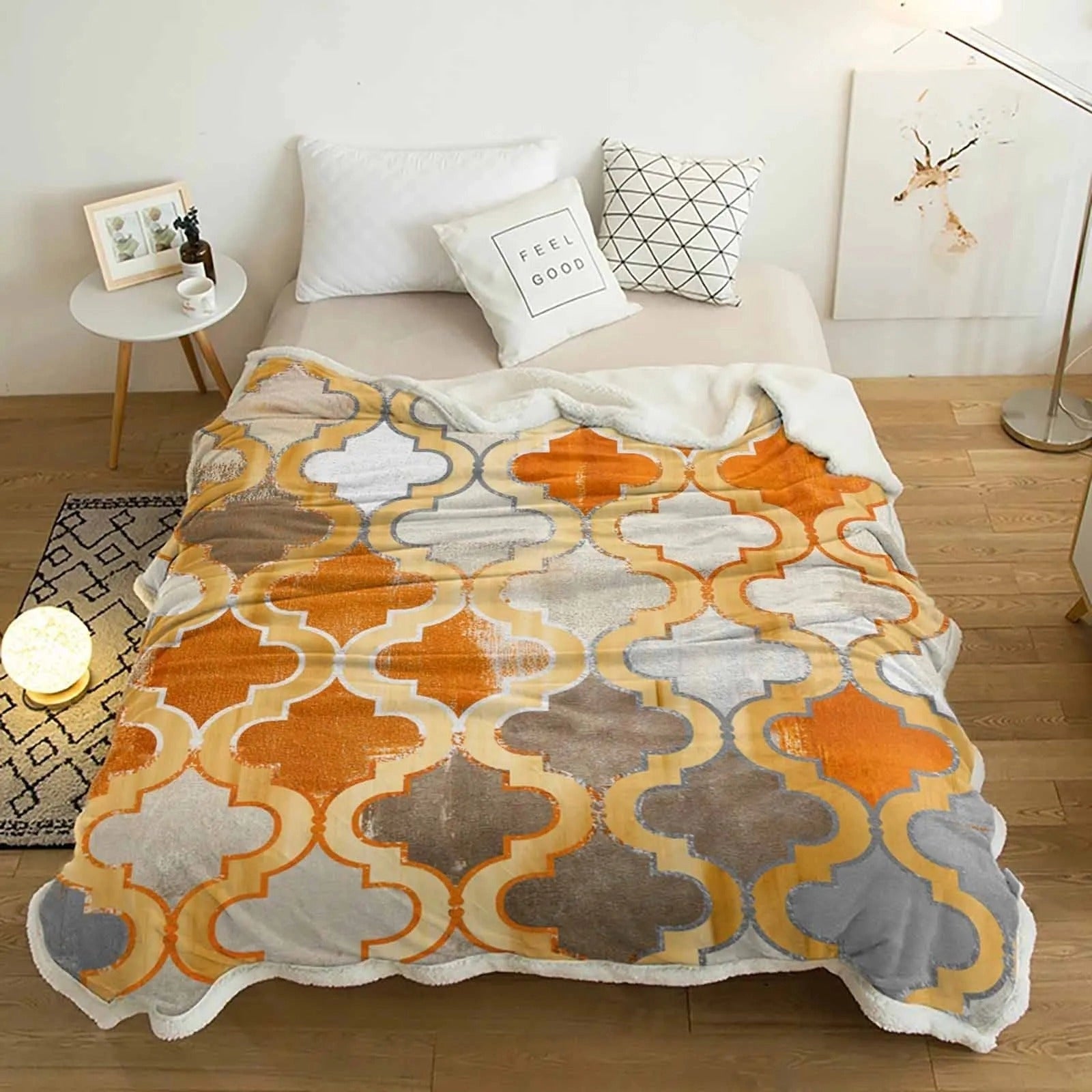 A cozy retro Moroccan orange cashmere blanket draped over a rectangular wooden table, enhancing the interior design with its vibrant textile pattern.