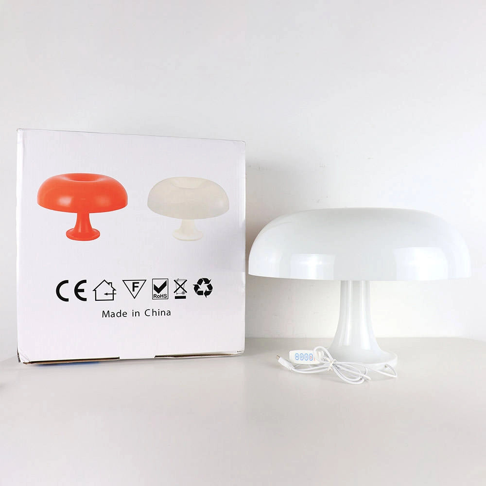 Retro Orange Mushroom Lamp in Mid-Century Modern style featuring a smooth, curvaceous form with a vibrant orange color, positioned on a wooden floor next to a piece of furniture, enhancing a stylish and artistic decor setting.