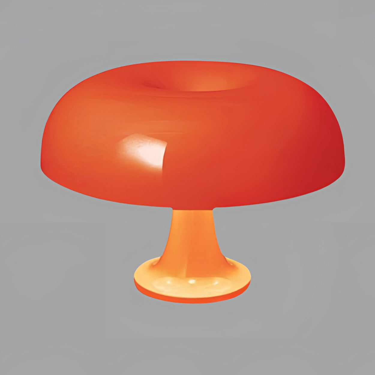 Retro orange mushroom lamp with a mid-century modern design, featuring a dome-shaped shade and sleek base, placed on a table.