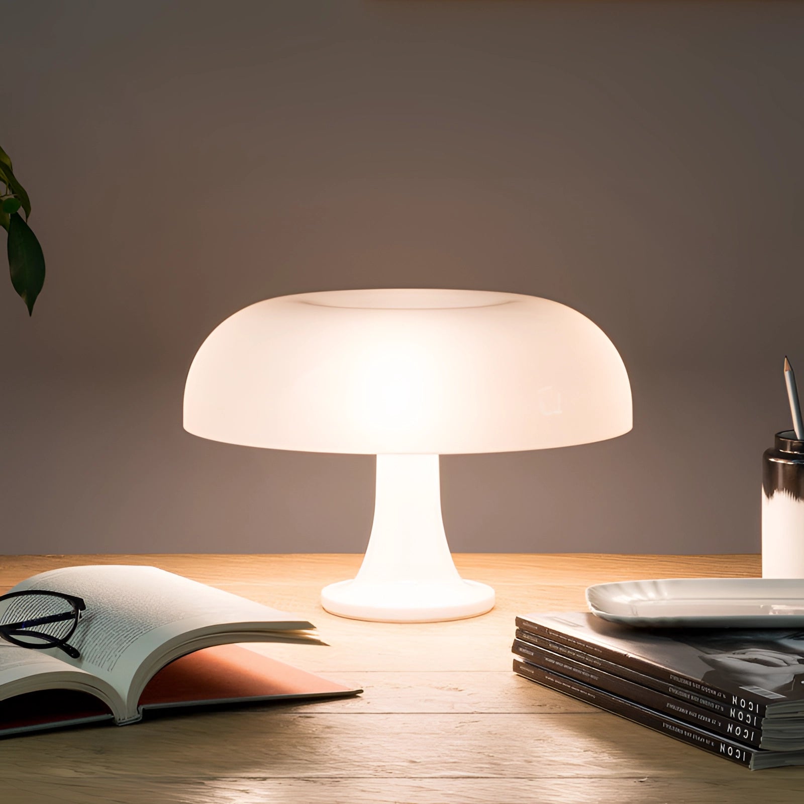 Retro orange mushroom lamp with a white shade, featuring a mid-century modern design, placed on a wooden table, illuminating the area with a soft, warm glow.