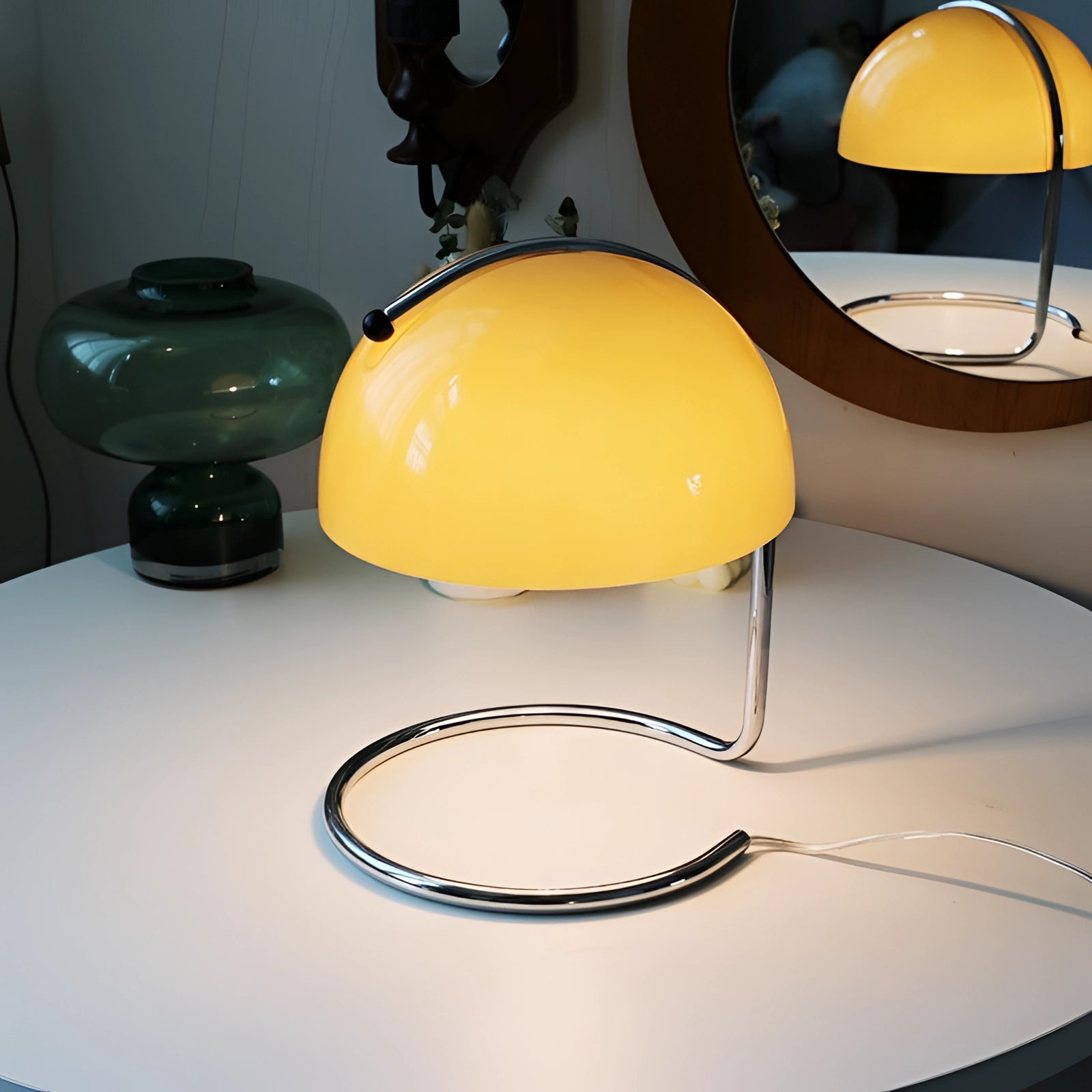 Retro yellow chrome mid-century desk lamp with a sleek and elegant design, featuring a circular base and shade, providing stylish and functional lighting for any table or workspace.