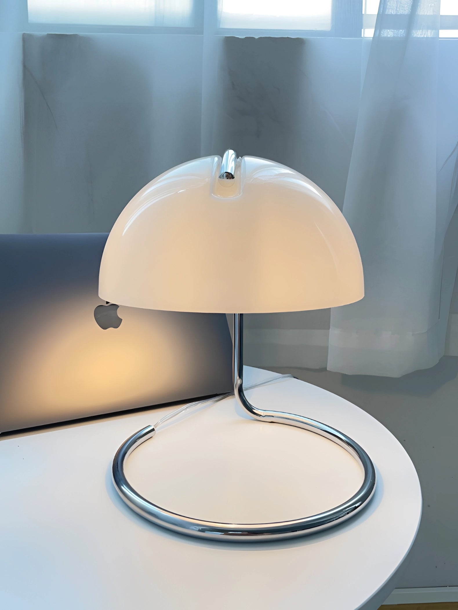 Retro Yellow Chrome Mid-Century Desk Lamp with an elegant and sleek design, placed on a wooden table in a stylishly furnished interior setting.