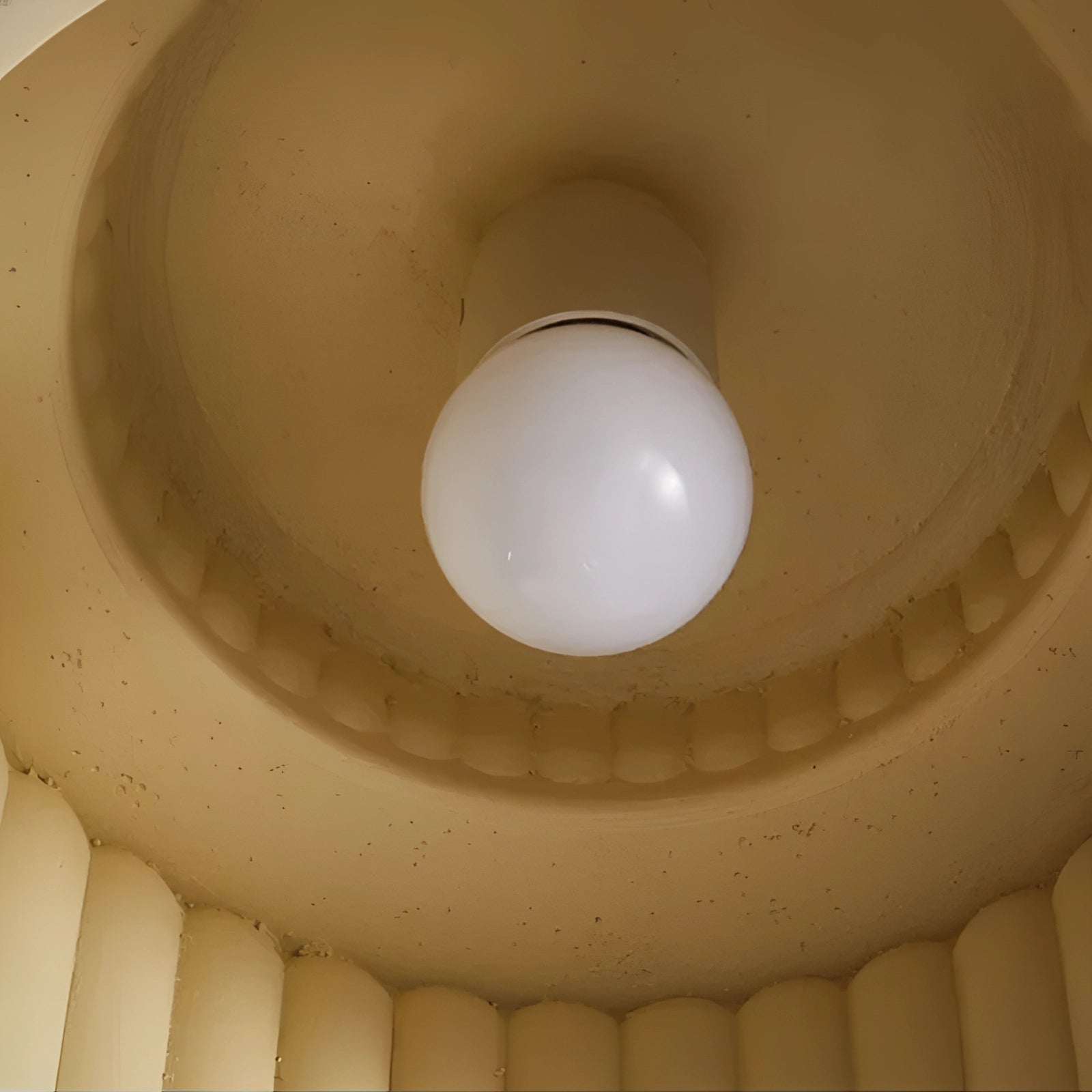 Ribbed LED pendant lamps with a modern design, featuring energy-efficient lighting, suspended from a wooden ceiling, showcasing a symmetrical circular fixture.