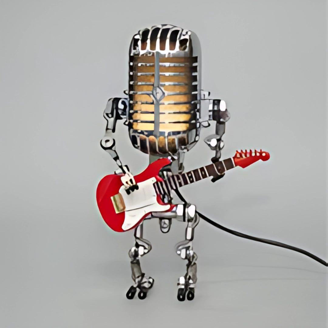 Robot musician figure in red, crafted from metal, holding a guitar and a microphone, standing next to a microphone stand.