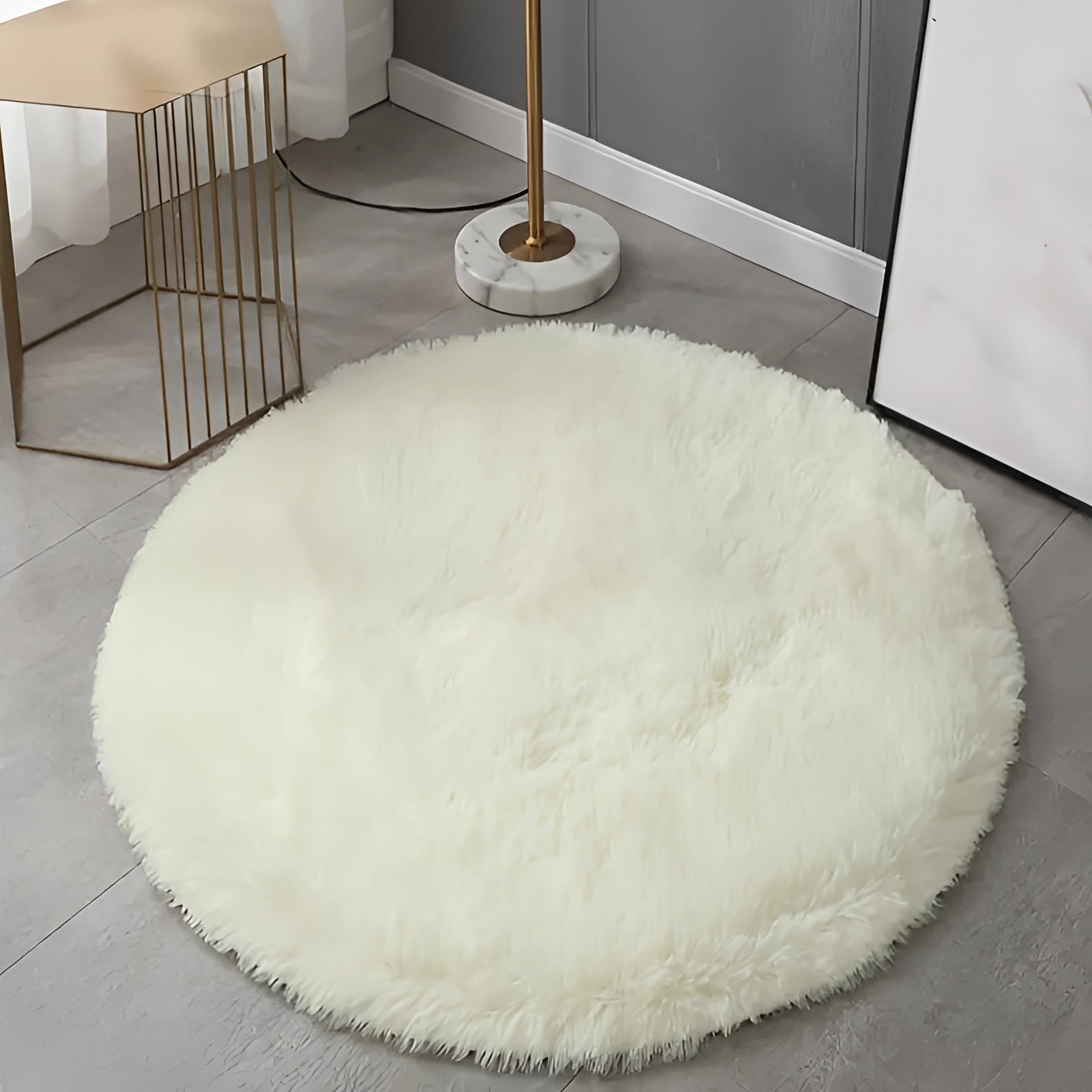 Round white faux fur rug on a hardwood floor, showcasing its plush and modern minimalist design.