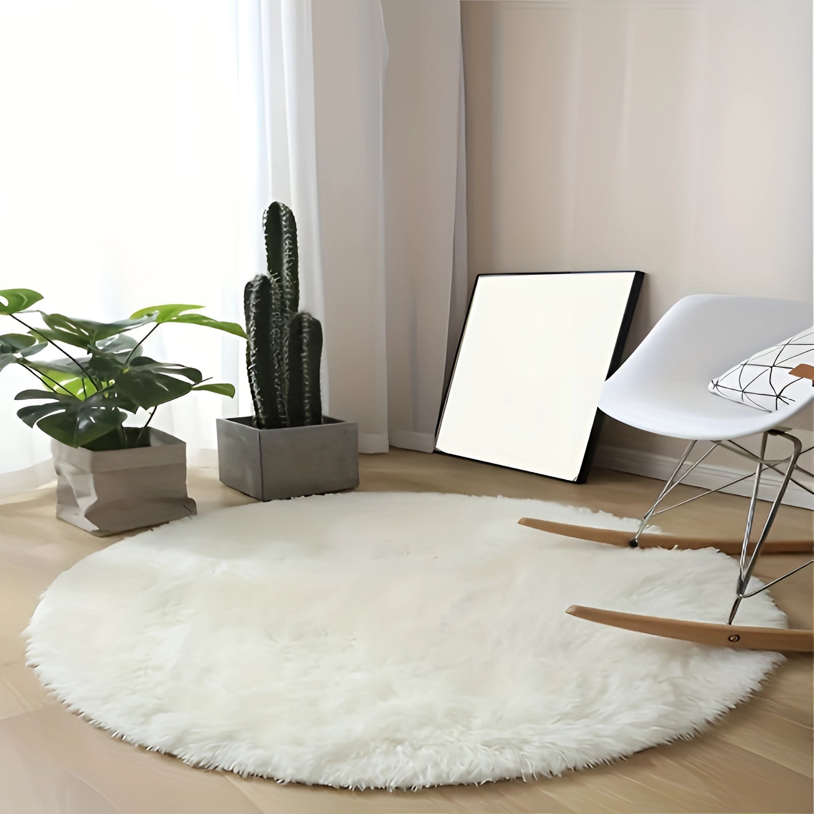 Round white faux fur rug on a wooden floor with houseplants nearby, featuring a plush texture and modern minimalist design.