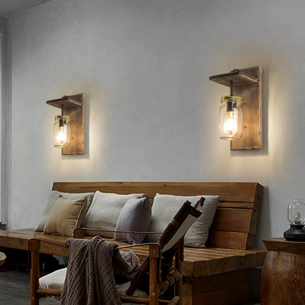 Rustic mason jar wood wall sconce mounted in a vintage farmhouse-style interior, complementing wood elements and cozy decor.