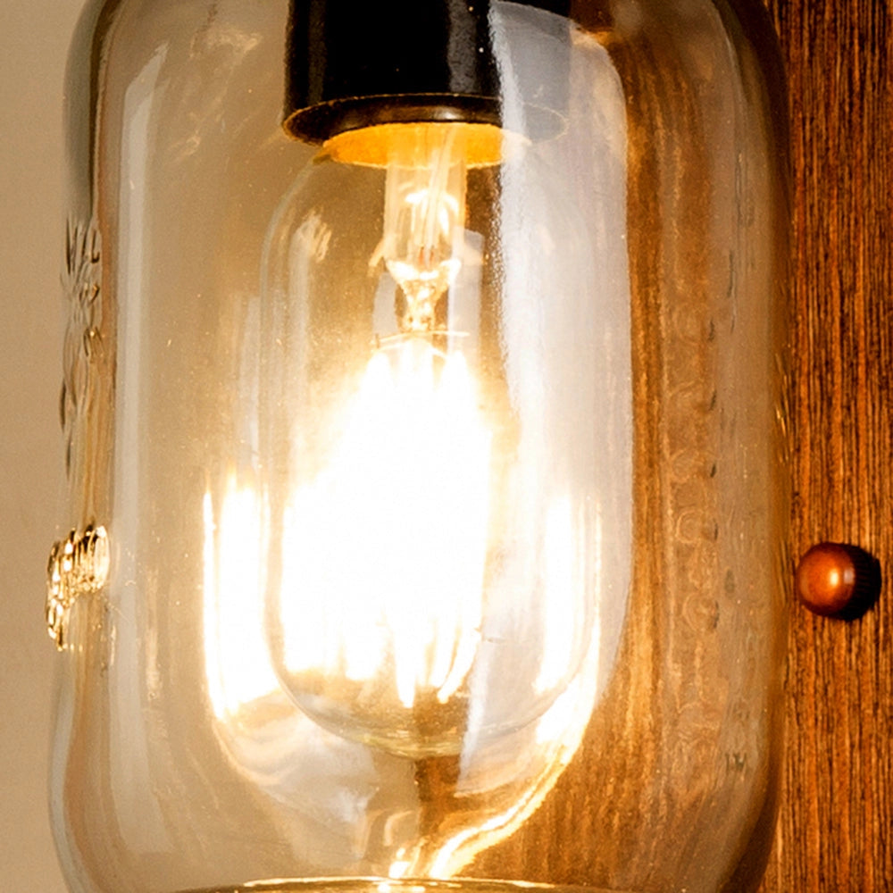 Rustic Mason Jar Wood Wall Sconce with vintage farmhouse design featuring a warm amber light bulb, mounted on a wooden base, ideal for adding a cozy and nostalgic touch to any space.