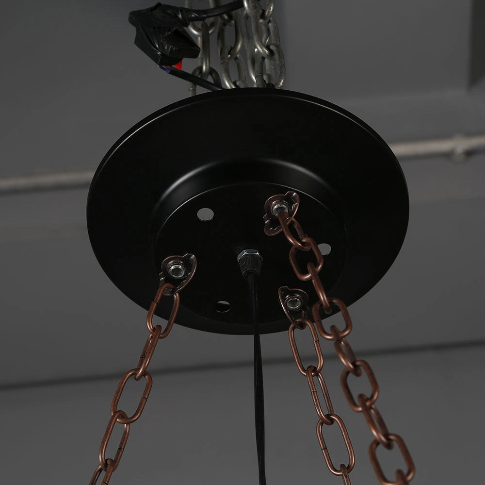 Rustic metal and wood chandelier featuring a circular design with metal and wire accents, suitable for cabin decor as a lighting fixture hanging from the ceiling.