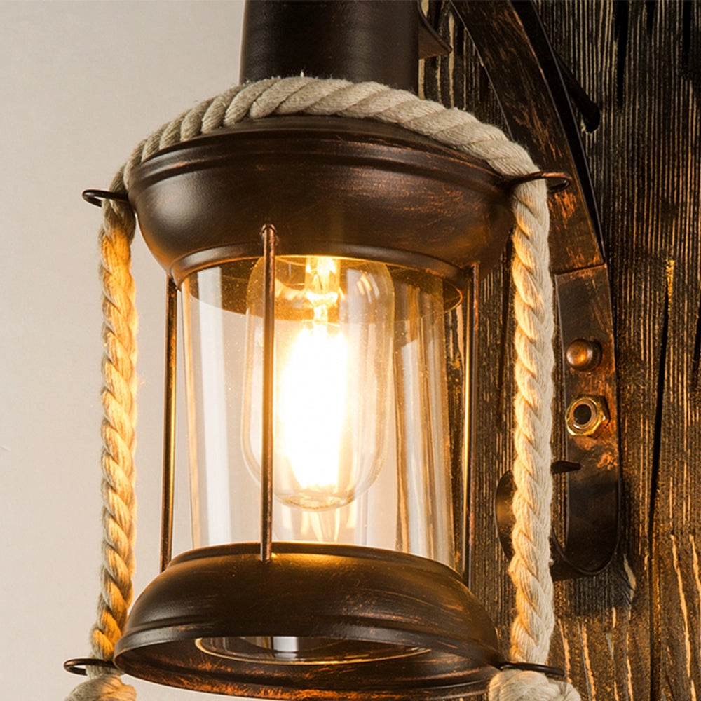 Vintage-style rustic nautical lantern sconce with wooden and metal elements, ideal for coastal decor, featuring a window-like frame and warm light tones.