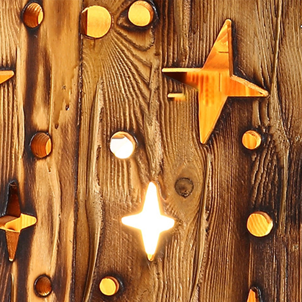 Rustic star cut-out wooden pendant light featuring a farmhouse design with a brown and amber finish, showcasing intricate wood patterns and a warm, golden glow.