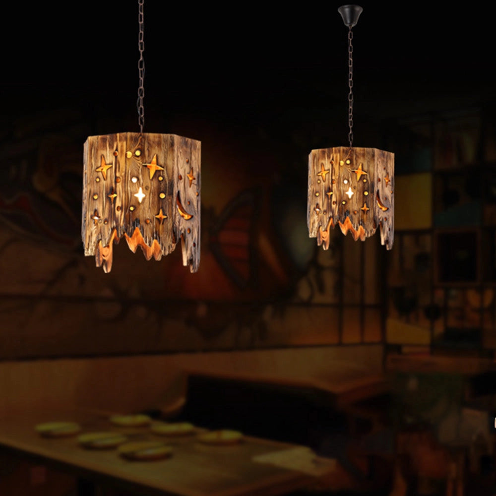 Rustic star cut-out wooden pendant light hanging from a ceiling, featuring warm amber tones and intricate wood craftsmanship, designed in a farmhouse style.
