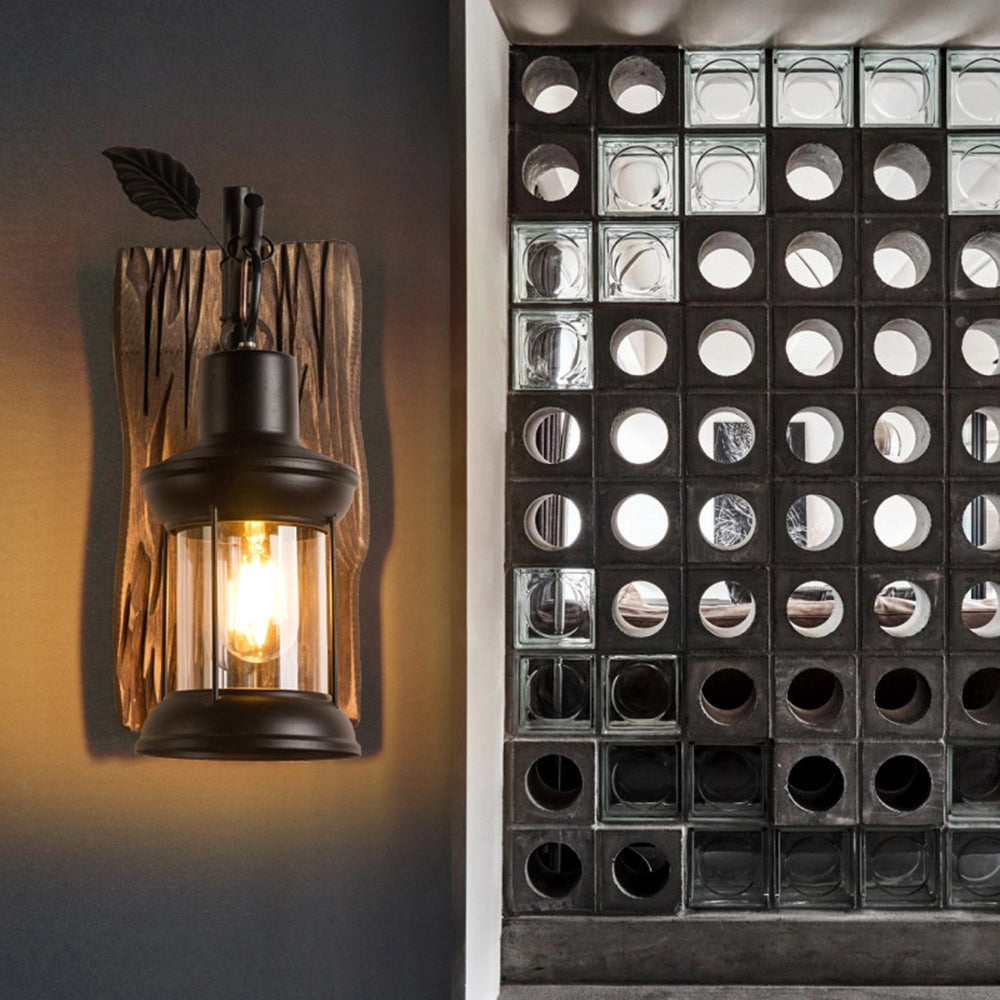 Rustic vintage lantern sconce with a H13.7" wooden mount featuring a metal and glass design, ideal for cabin lighting.