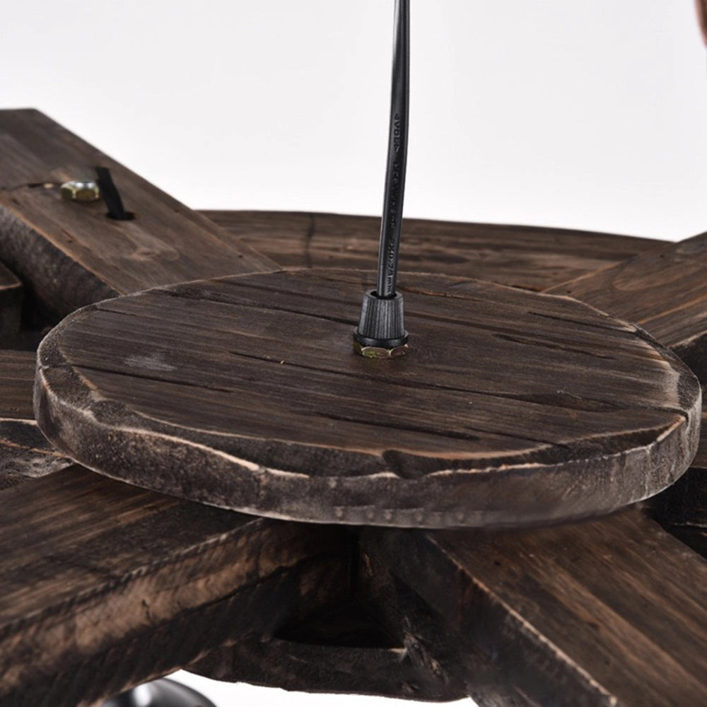 Rustic wagon wheel farmhouse chandelier featuring vintage lantern-style lights with a wooden and metal design.