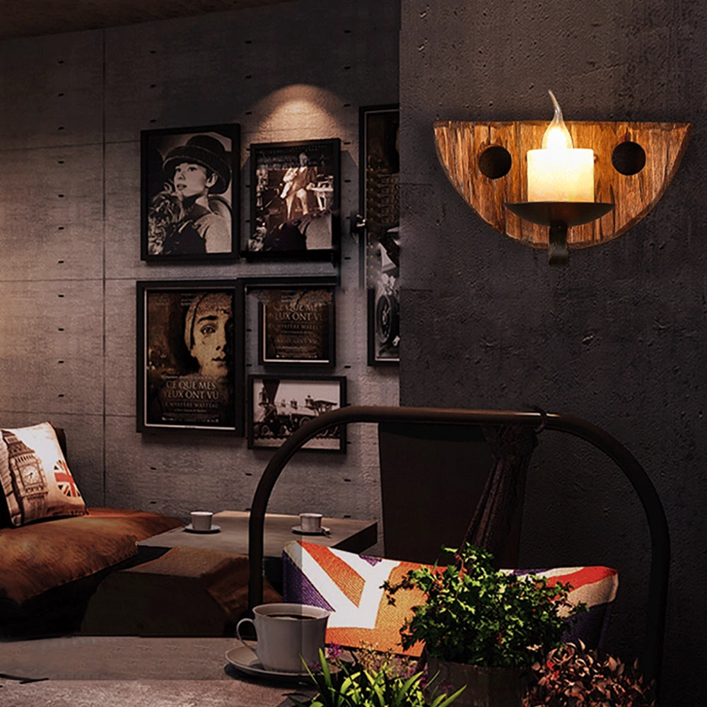 Rustic wooden wall sconce with a vintage candle holder design displayed on a farmhouse-style wall, surrounded by elements of interior decor such as a plant, lamp, and picture frame, enhancing the warm and cozy ambiance of the room.