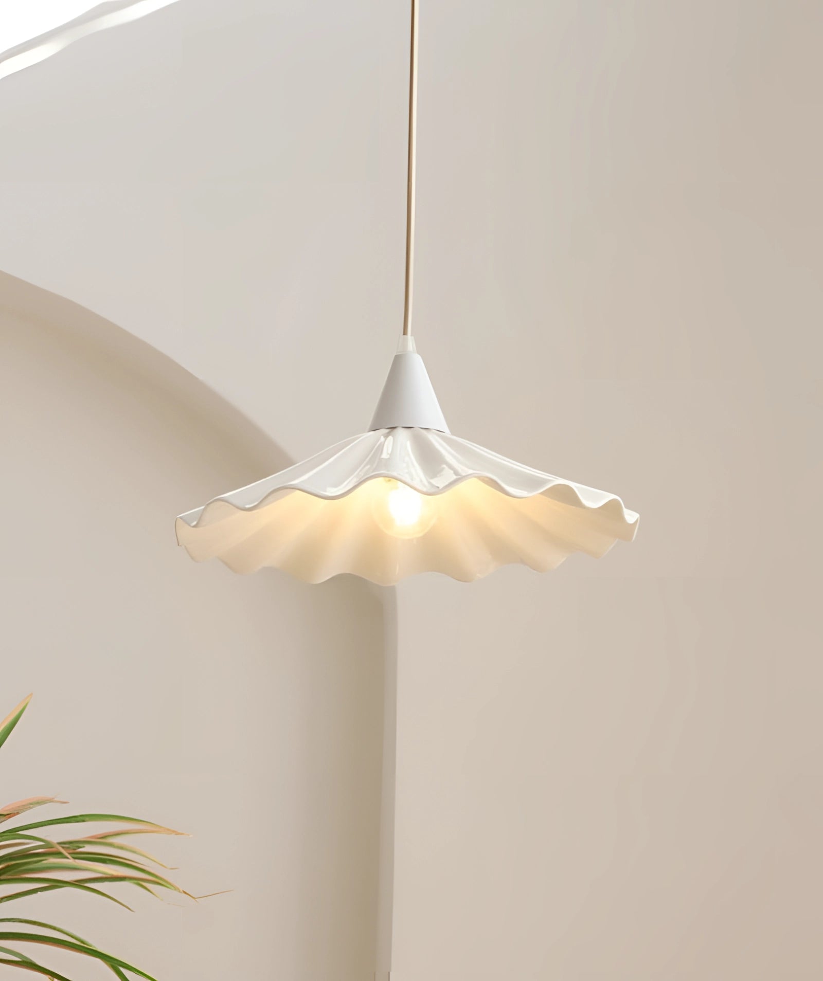 Scallop-edged LED pendant light with a modern decorative design, featuring a wood and metal construction and a symmetrical shade, hanging from the ceiling.