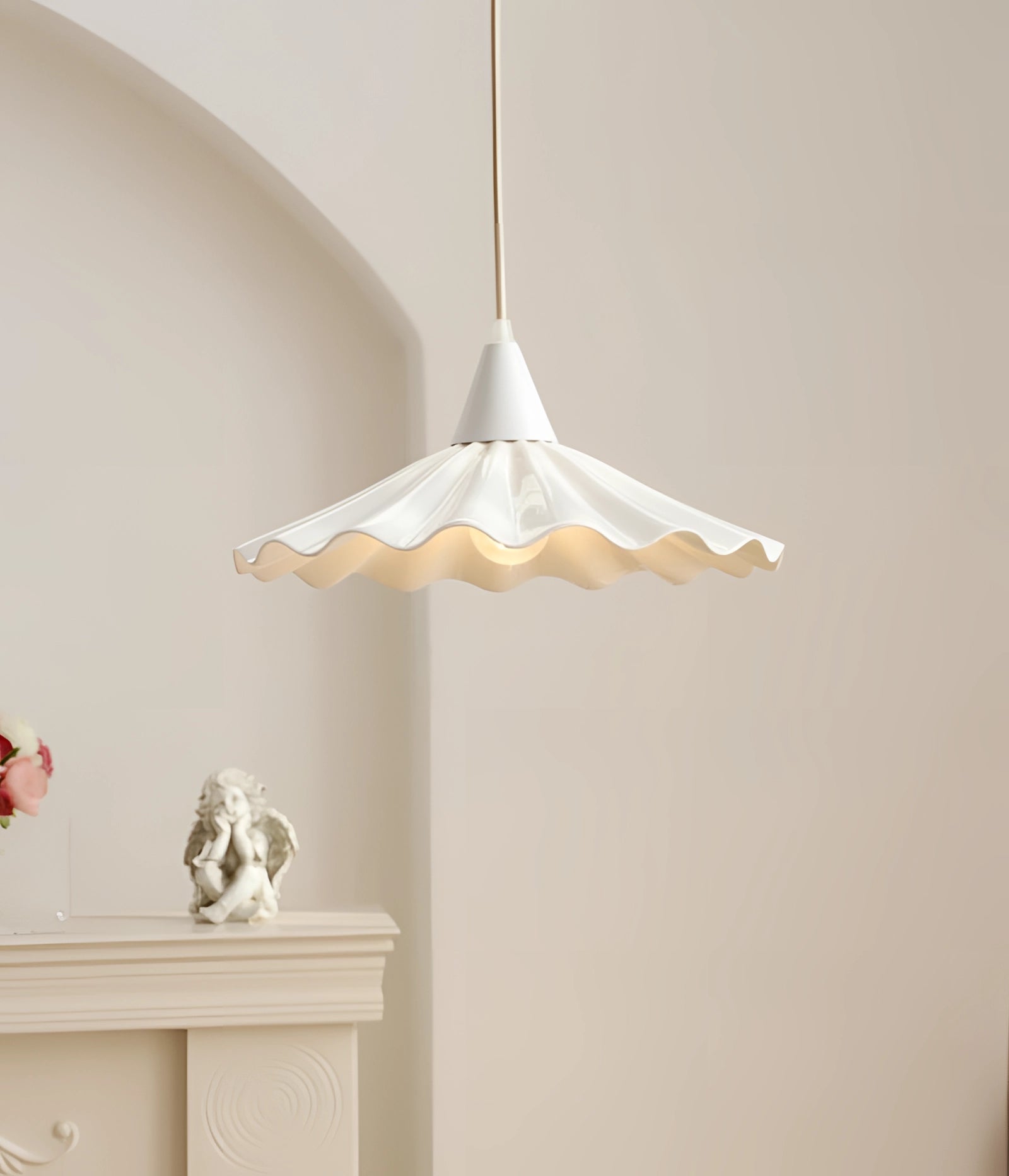 Scallop-edged LED pendant light with modern decorative design, featuring a soft glow and elegant ceiling fixture, suspended in a room with wooden accents.
