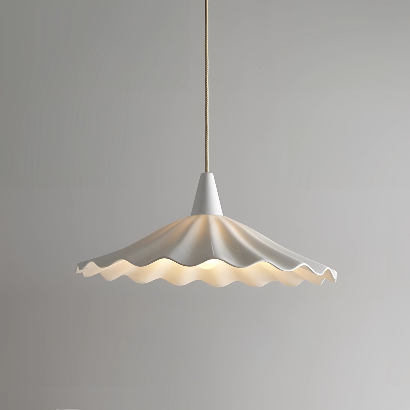 Scallop-edged LED pendant light with a modern design, featuring a single head and artistic origami-inspired triangular shapes, hanging from the ceiling.