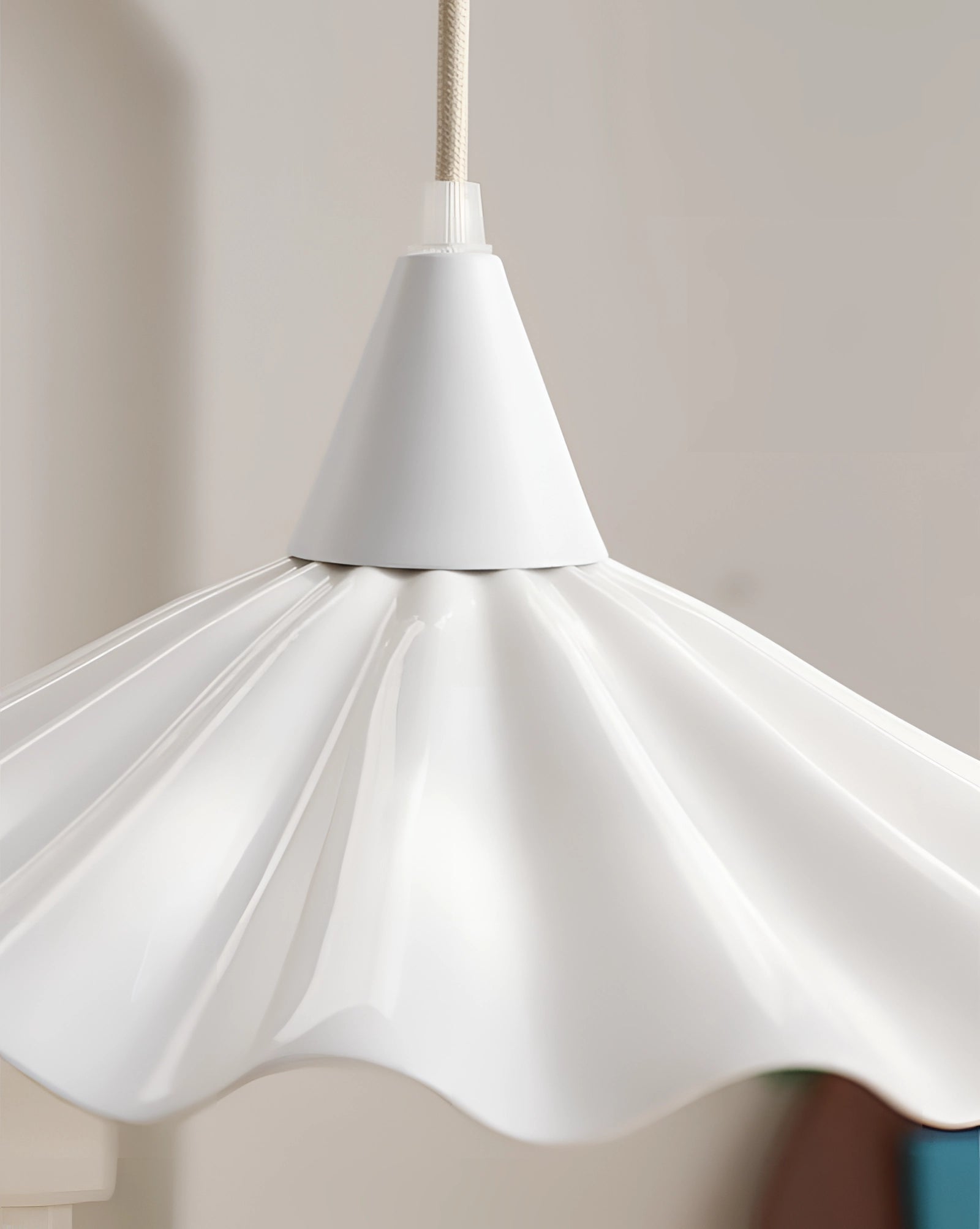 Scallop-edged LED pendant light with a modern decorative design hanging from the ceiling, showcasing a unique art-inspired sculptural form.