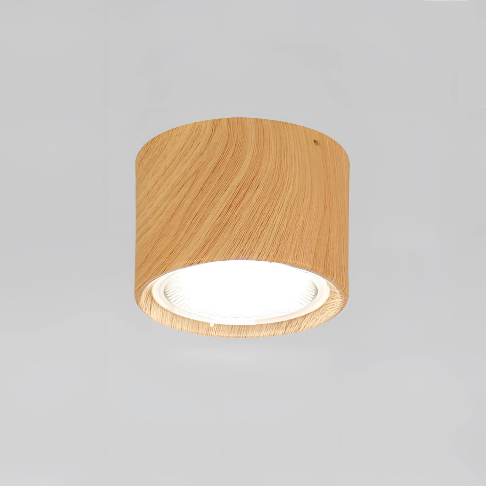 Scandinavian LED spotlight with a light wood finish, featuring a modern design. The fixture is mounted on the ceiling and emits a warm light (3000K), highlighting its combination of wood and metal elements.