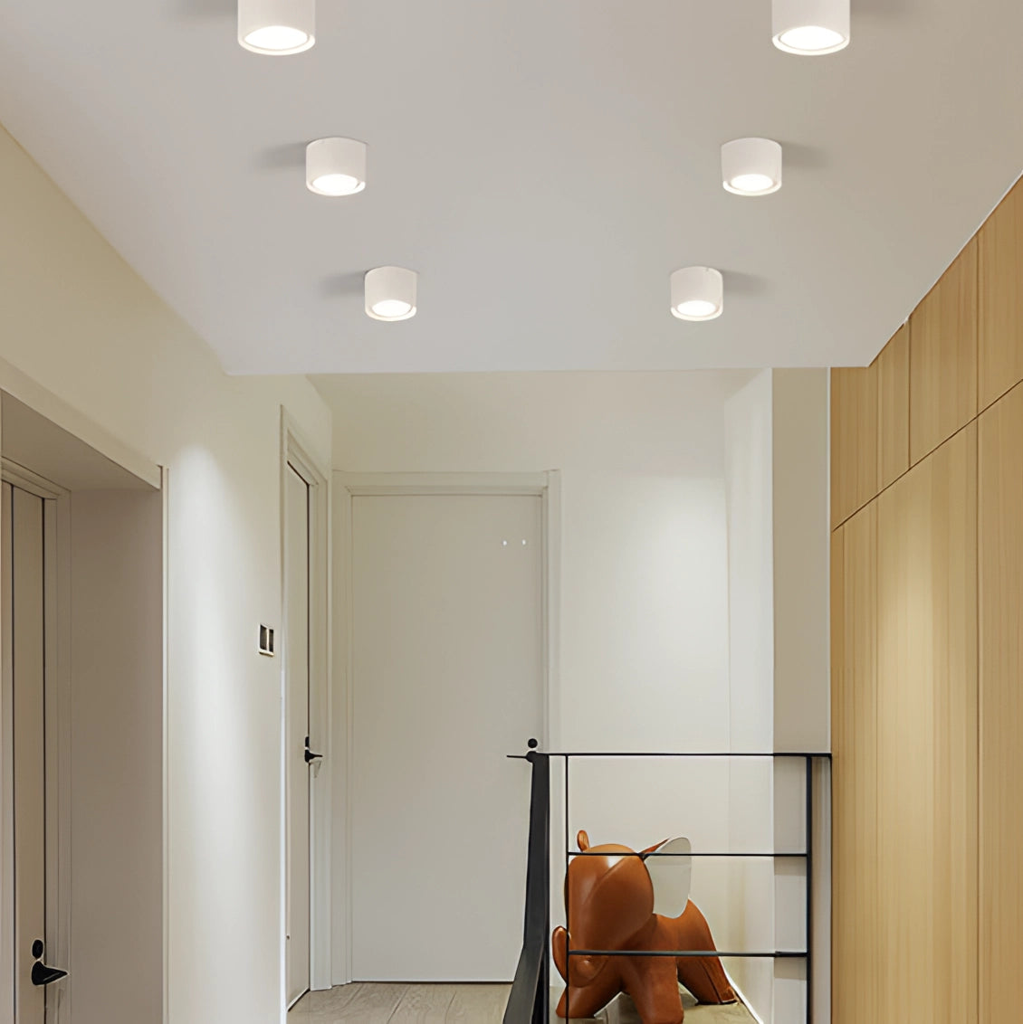 Scandinavian LED spotlight with a light wood finish, mounted on the ceiling of a modern kitchen with minimalist interior design elements.