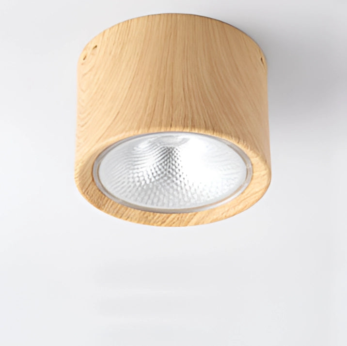 A modern Scandinavian LED spotlight with a light wood finish, featuring a cylindrical design and mounted on a rectangular wooden base, suitable for ceiling installation in a kitchen setting.