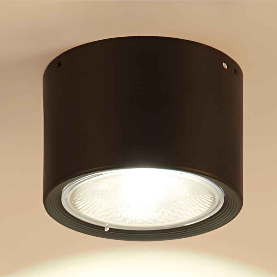 Scandinavian LED spotlight with a modern design, featuring a light wood finish mounted on a ceiling, illuminating a kitchen space with a sleek, cylindrical shape.