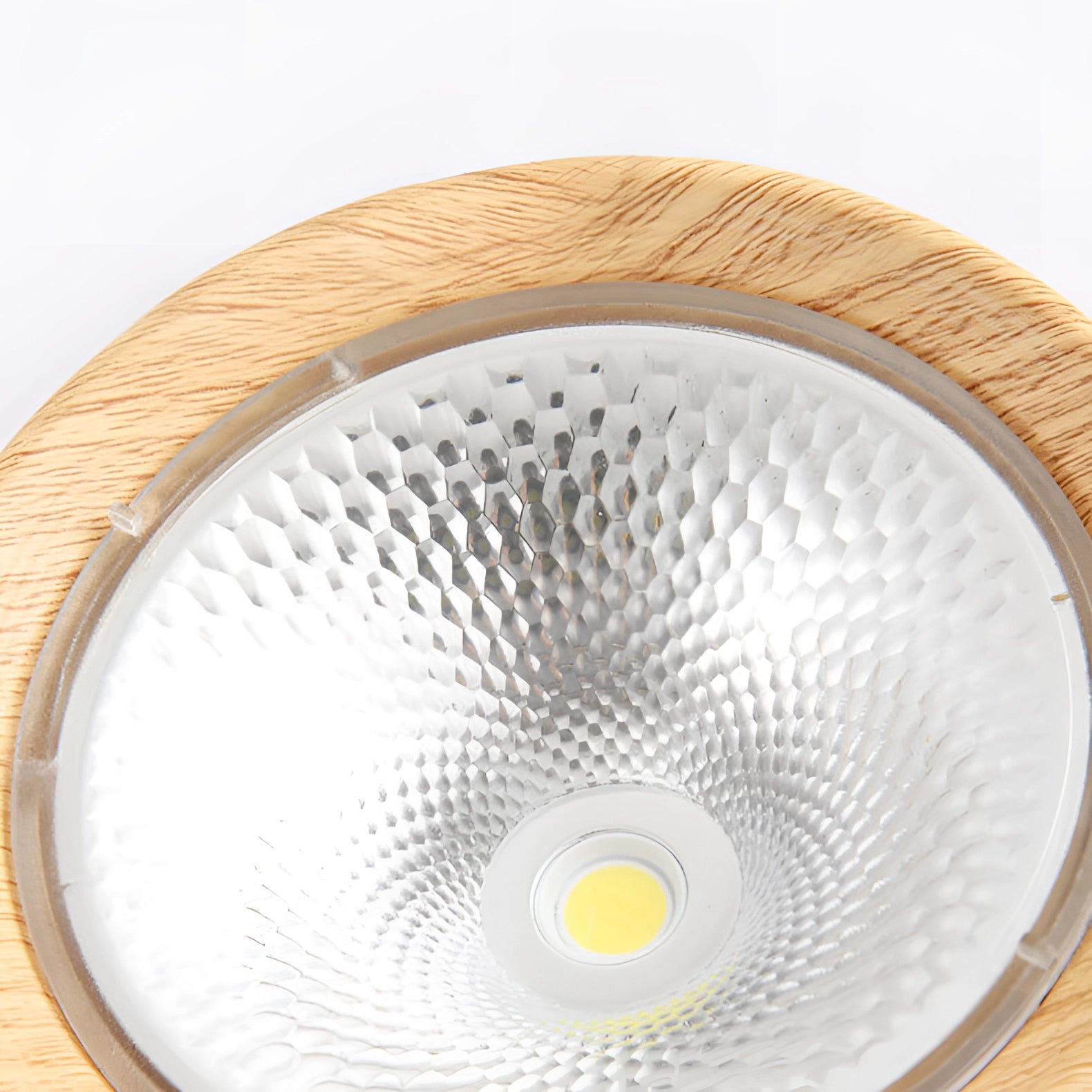 Modern kitchen with Scandinavian-style LED spotlight featuring a light wood finish. The ceiling light is designed with a circular and rectangular pattern, illuminating the space that includes dishware and serveware. The setting combines metal and home appliance elements, creating a stylish and functional kitchen atmosphere.