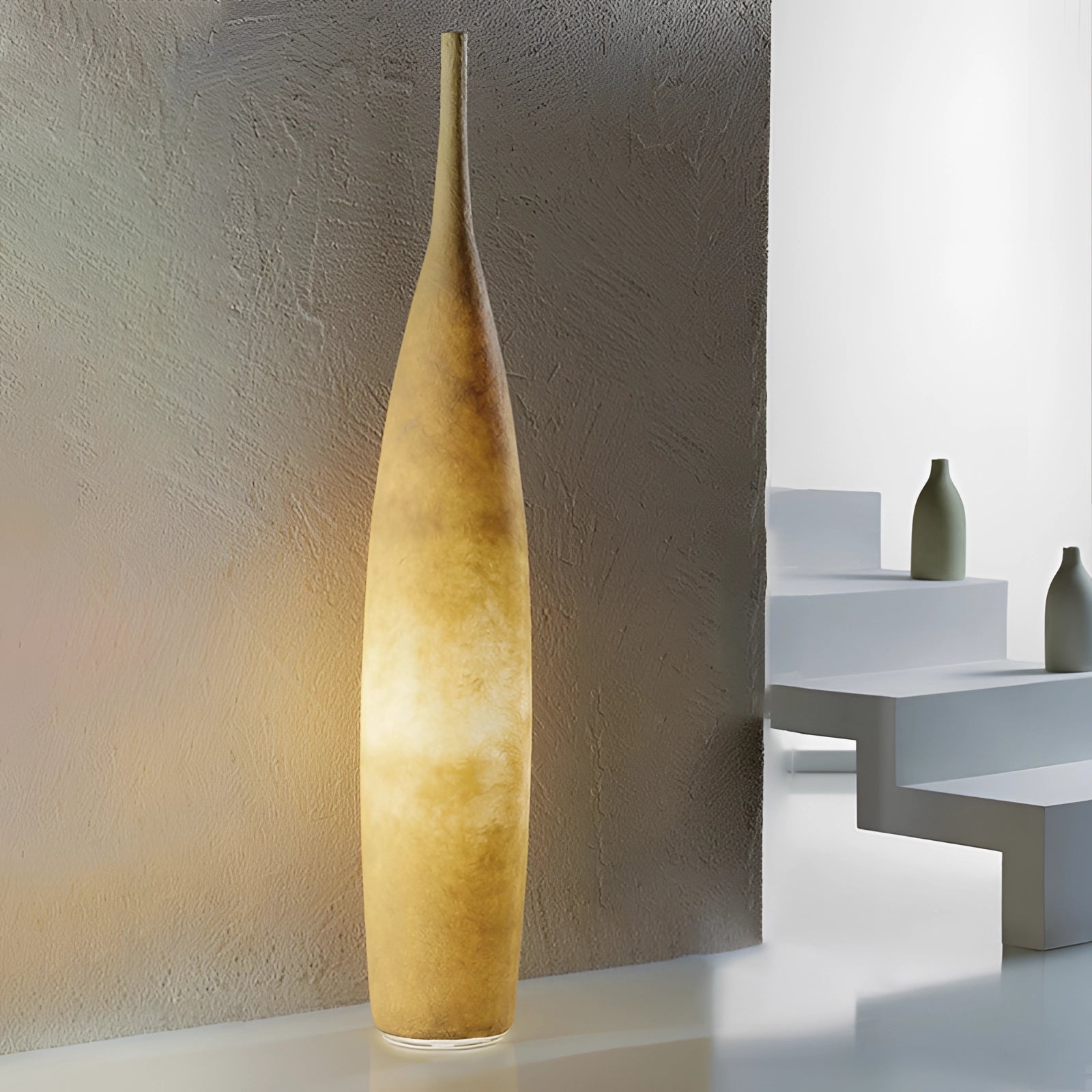 Tall narrow yellow ceramic vase with a Scandinavian minimalist design and distressed finish, displayed in an interior setting with wooden elements.