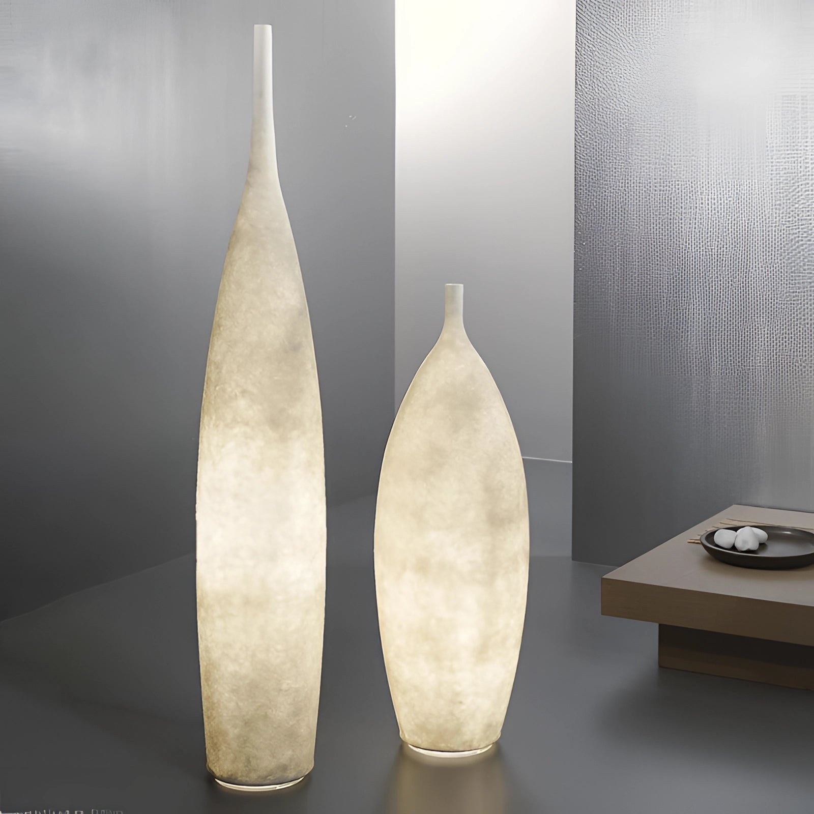 Tall narrow ceramic vase with a distressed finish, showcasing Scandinavian minimalist design, placed on a wooden table.