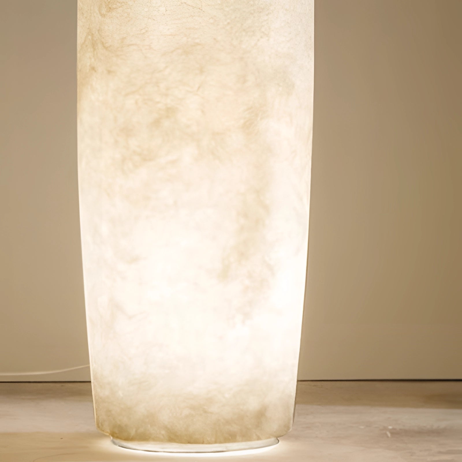 Tall narrow ceramic vase with a distressed finish, featuring a minimalist Scandinavian design.