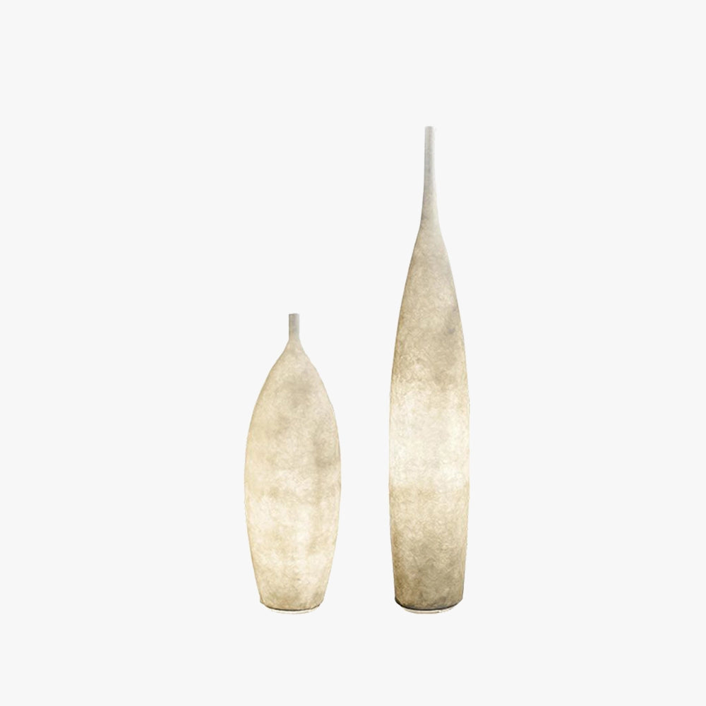 Tall narrow ceramic vase with a distressed finish, designed in a Scandinavian minimalist style, placed on a wooden surface.