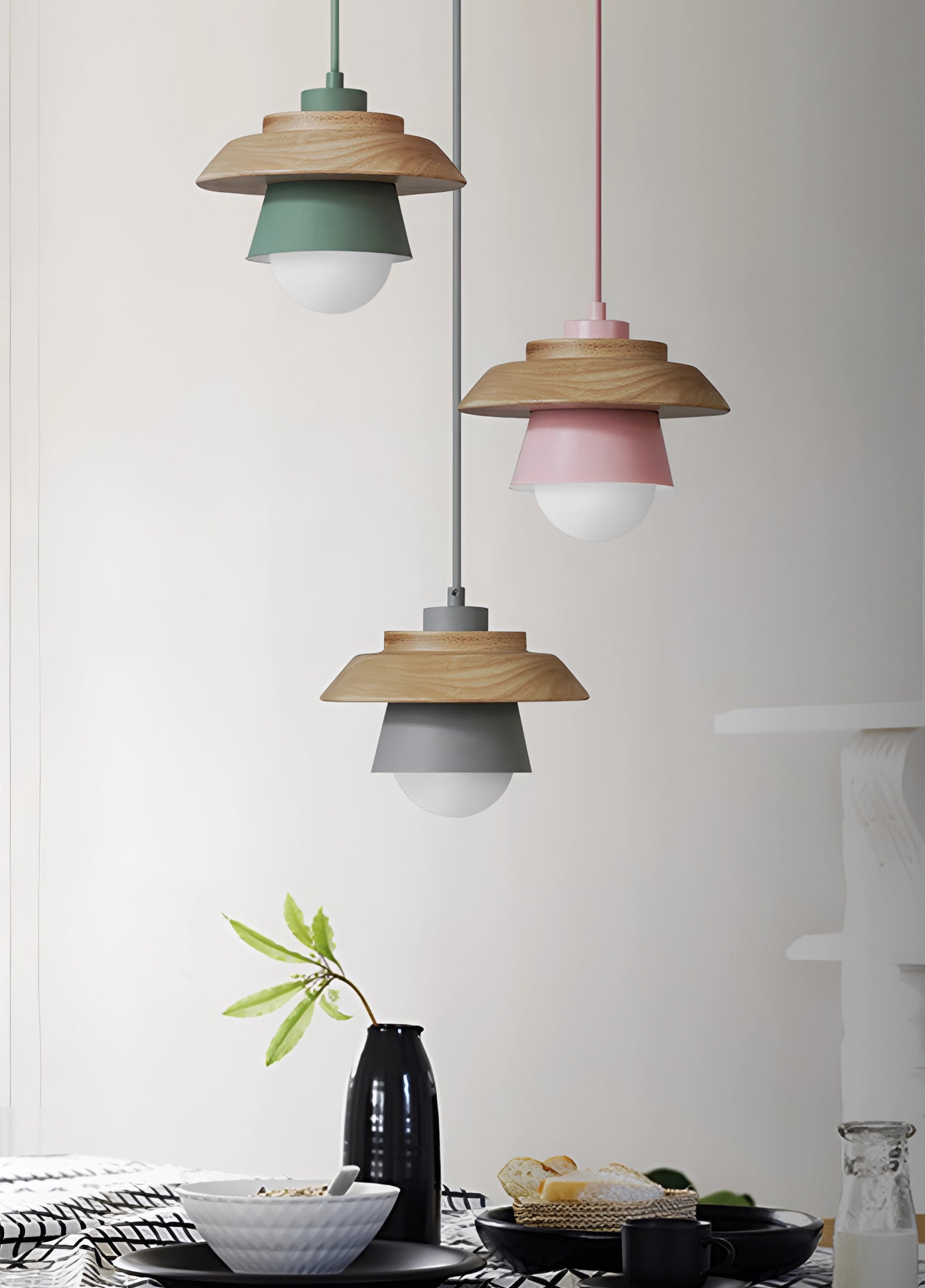 Scandinavian minimalist wooden pendant light with an adjustable ceiling fixture, featuring a sleek design in white and grey tones, complemented by a wooden accent and surrounded by a modern interior design setting with a green plant and neutral-colored walls.