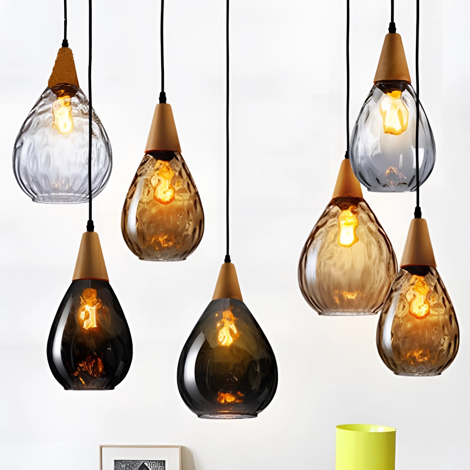 Scandinavian teardrop pendant light with smoked glass and wood accent, featuring a warm amber glow, mounted as a ceiling fixture.
