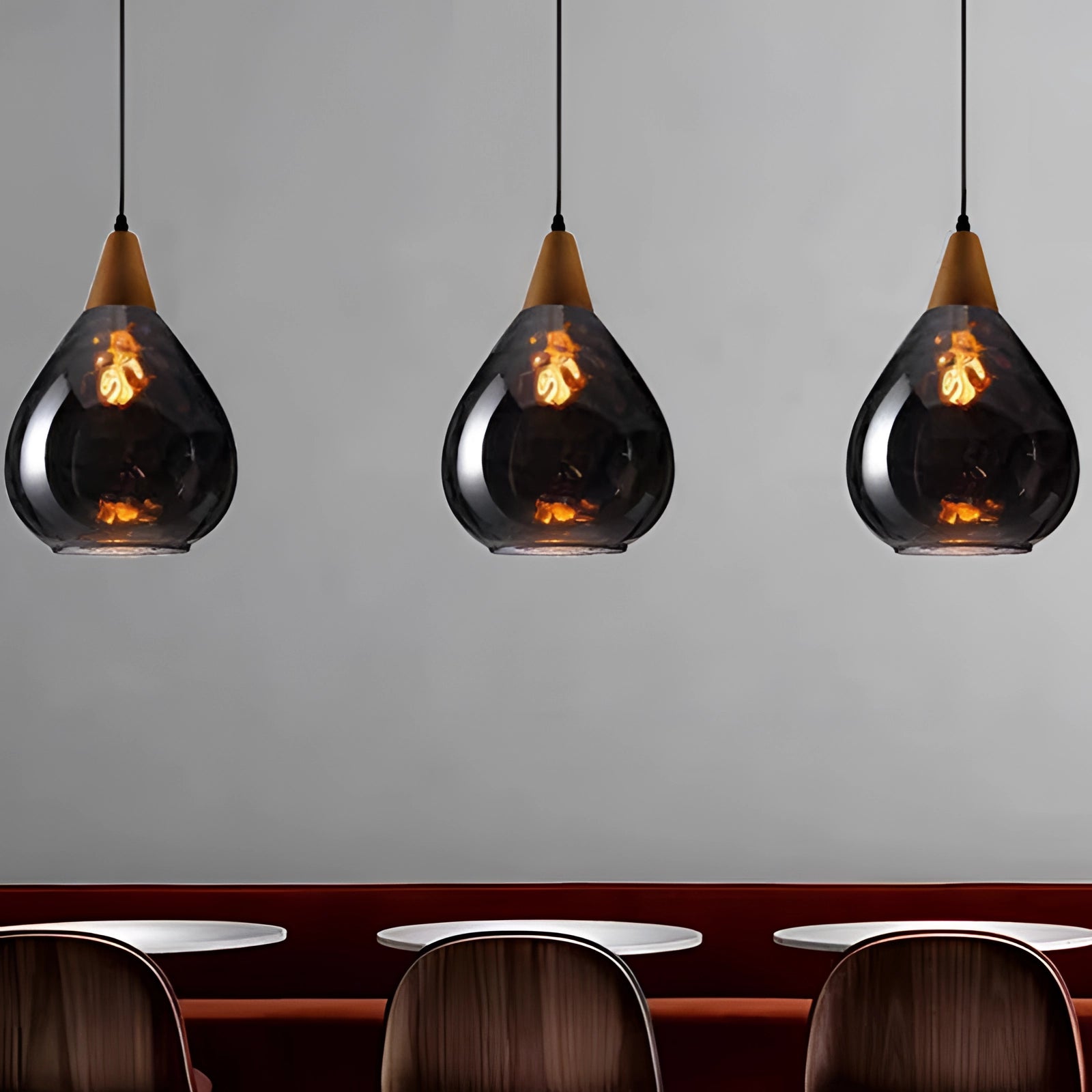 Scandinavian teardrop pendant light featuring a smoked glass shade in smoke gray, with wood accents and an elegant design, suspended against a neutral background.