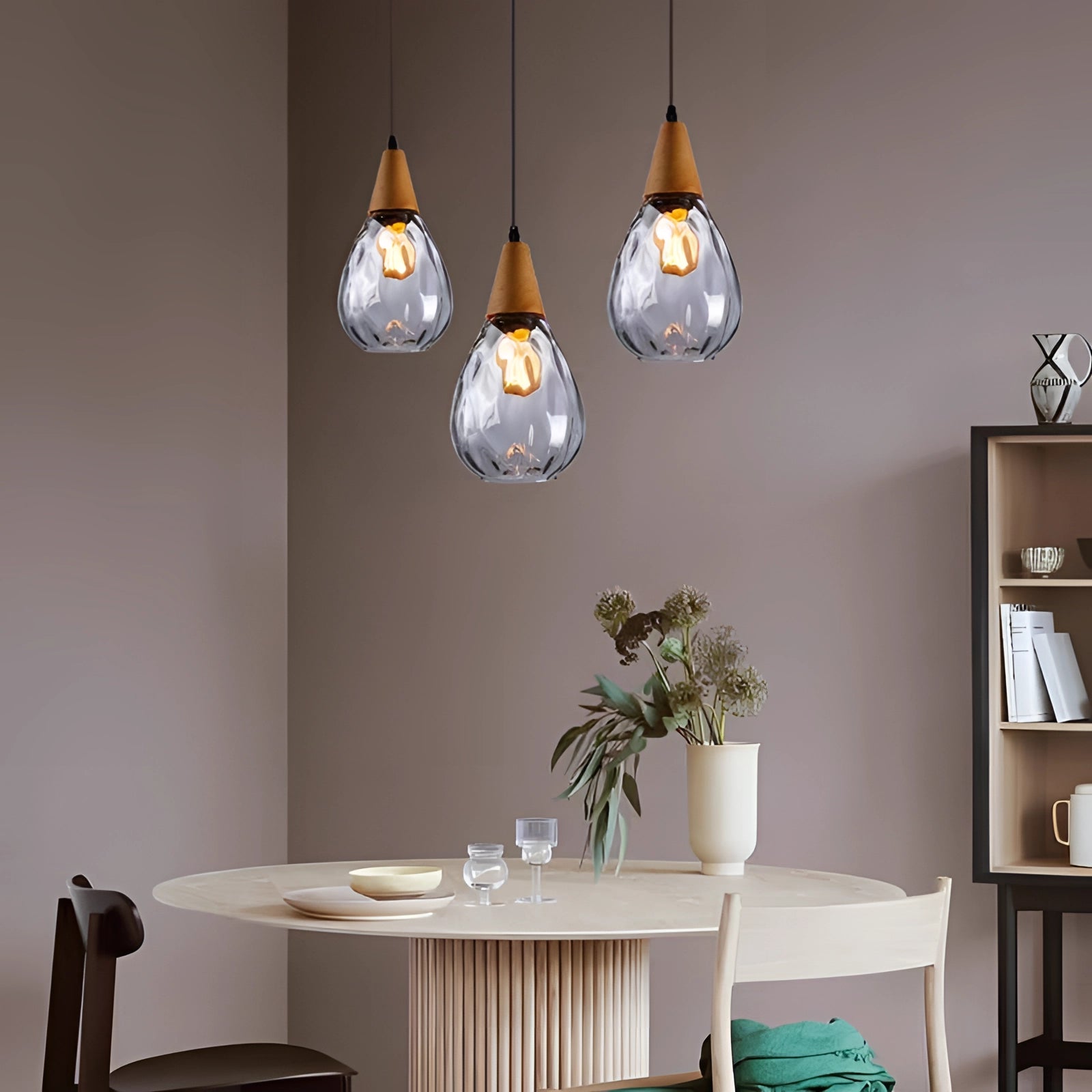 Scandinavian Teardrop Pendant Light with Smoked Glass and Wood Accent, featuring a clear glass finish and a B-6" size, hanging from a ceiling in a modern interior setting with wood and grey decor elements.