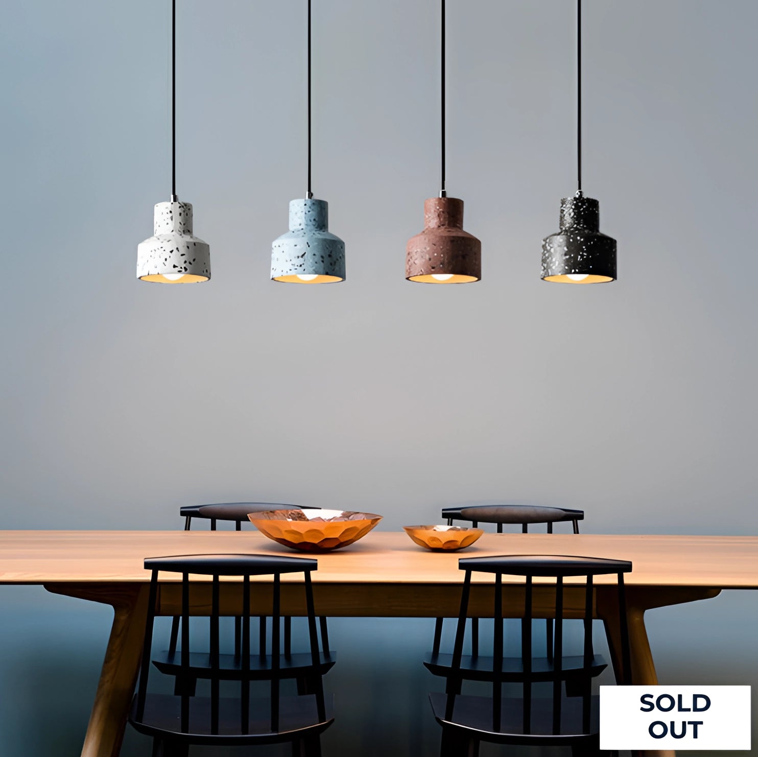 Scandinavian Terrazzo Pendant Lights illuminating a modern minimalist interior setting with wooden furniture and shelving.