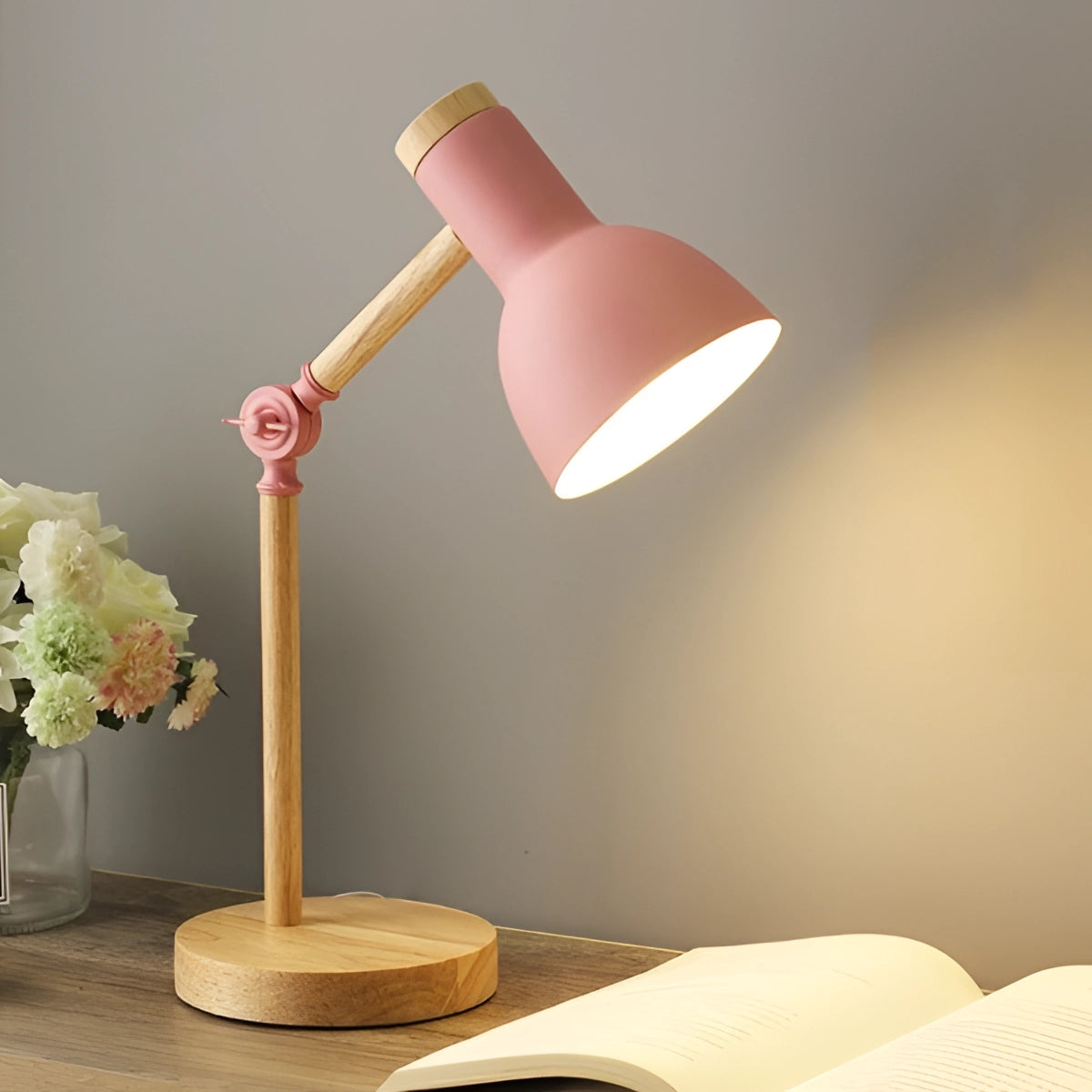 Scandinavian retro-style adjustable LED desk lamp in pink, featuring a wooden base and adjustable arm, with a three-color switch and a flower-shaped lampshade.