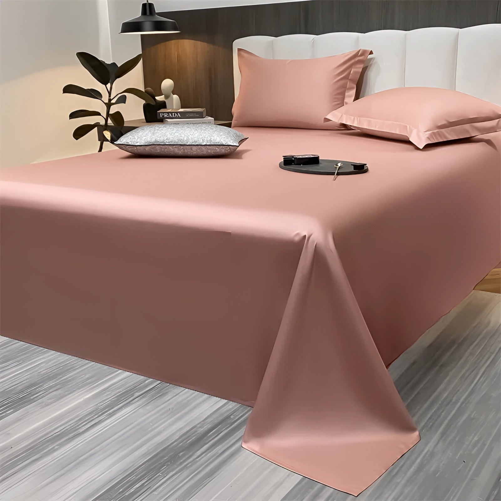 Sea green silky luxury bed sheets in a peach color, elegantly draped on a bed in a modern minimalist bedroom setting. The sheets have a smooth, lustrous surface, complementing the simple and sophisticated decor.